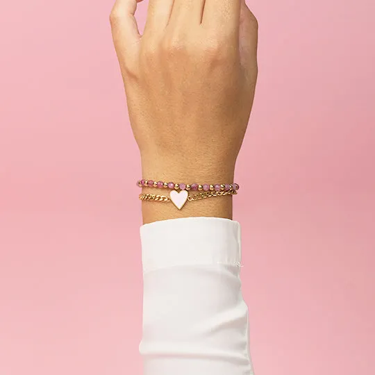 Gold coloured bracelet with pink heart charm