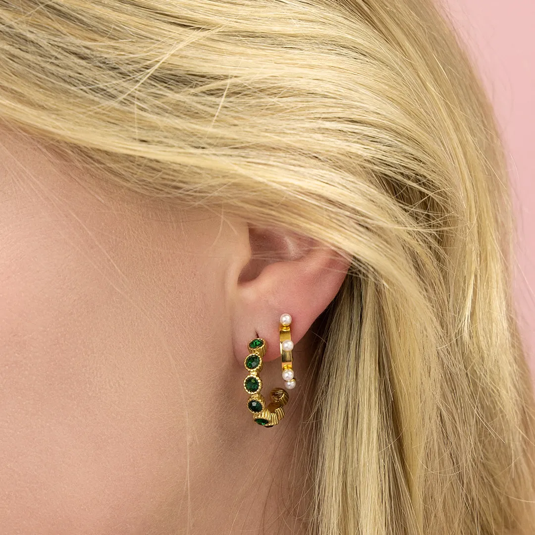 Gold coloured earrings with green stones