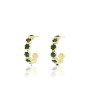 Gold coloured earrings with green stones