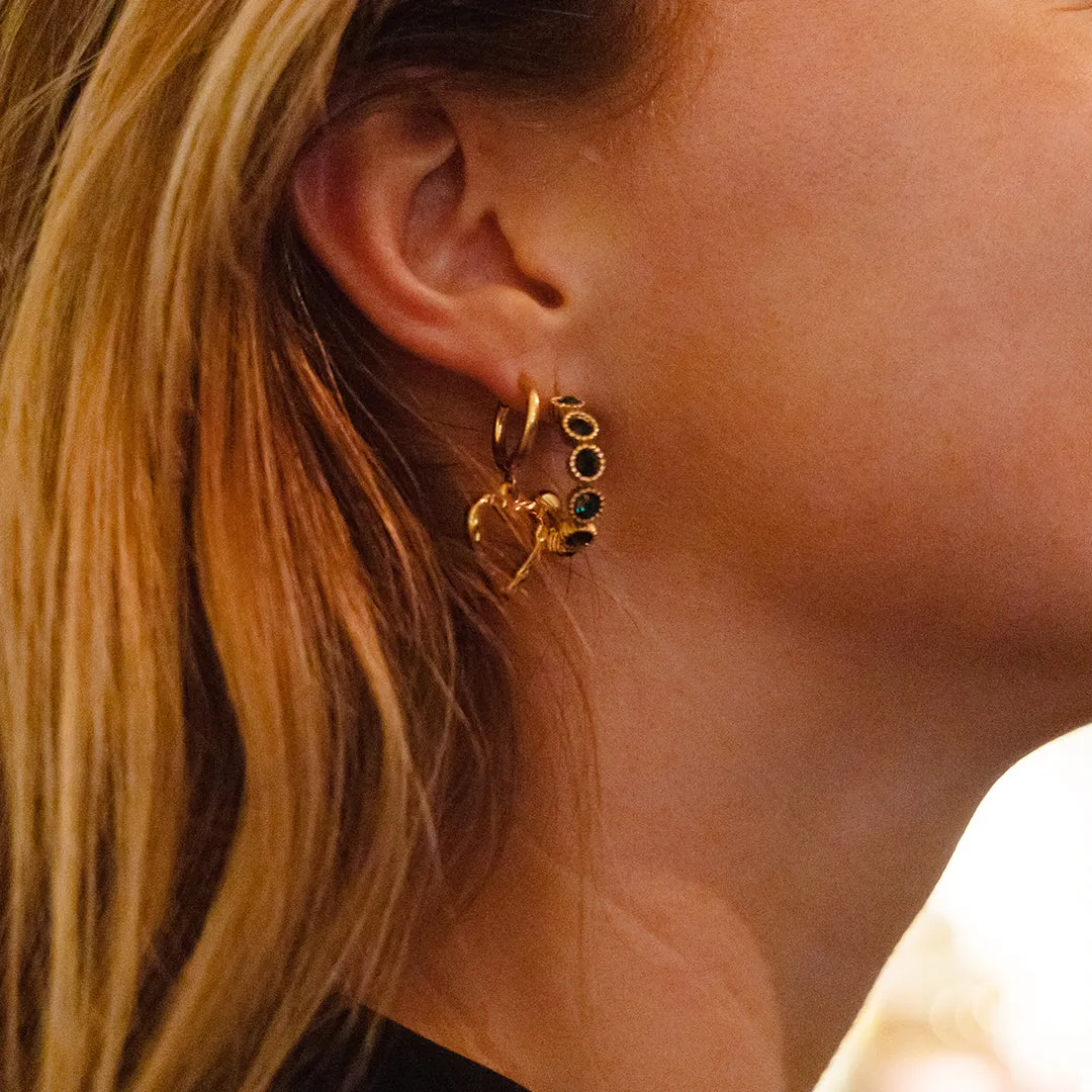 Gold coloured earrings with green stones